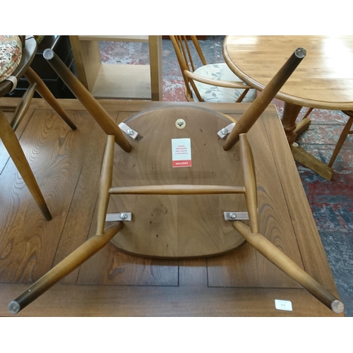 173 - An Ercol Golden Dawn elm draw leaf dining table and four Fleur De Lys chairs - table approx. 75cm hi... 