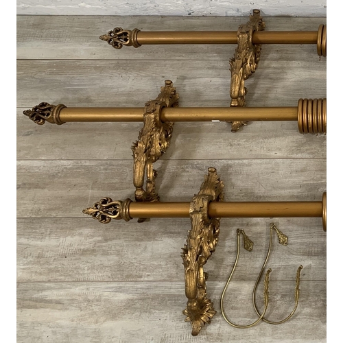 174 - Three Rococo style gilt plaster curtain poles with six brackets, four tie backs and two further meta... 