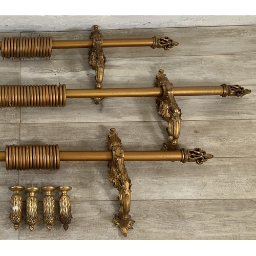 174 - Three Rococo style gilt plaster curtain poles with six brackets, four tie backs and two further meta... 