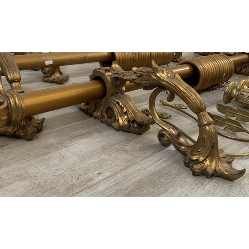 174 - Three Rococo style gilt plaster curtain poles with six brackets, four tie backs and two further meta... 