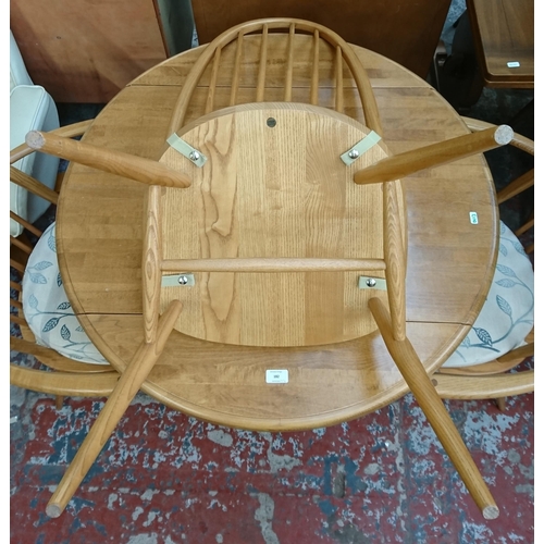 182 - Four pieces of furniture, three Ercol Windsor blonde elm dining chairs and one beech circular pedest... 