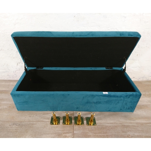 186 - A modern teal fabric upholstered blanket box on gilt metal supports - approx. 29cm high x 109cm wide... 