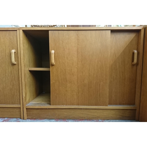 187 - Two mid/late 20th century oak two door office cabinets - approx. 72cm high x 91cm wide x 46cm deep