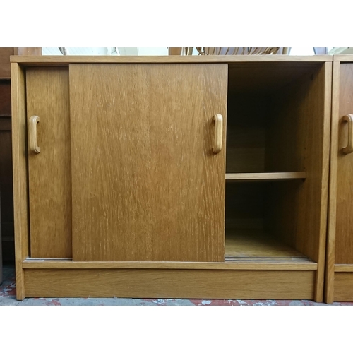 187 - Two mid/late 20th century oak two door office cabinets - approx. 72cm high x 91cm wide x 46cm deep