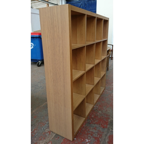 188 - A modern oak effect sixteen section cube shelving unit - approx. 157cm high x 155cm wide x 36cm deep