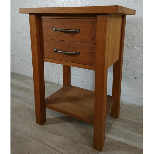 191 - A modern oak two drawer side table - approx. 65cm high x 50cm wide x 35cm deep