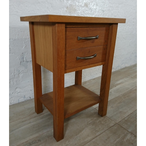 191 - A modern oak two drawer side table - approx. 65cm high x 50cm wide x 35cm deep