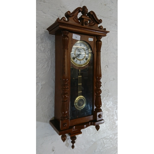 194 - Six items, one Highlands oak cased chiming wall clock with pendulum and key and five various mirrors