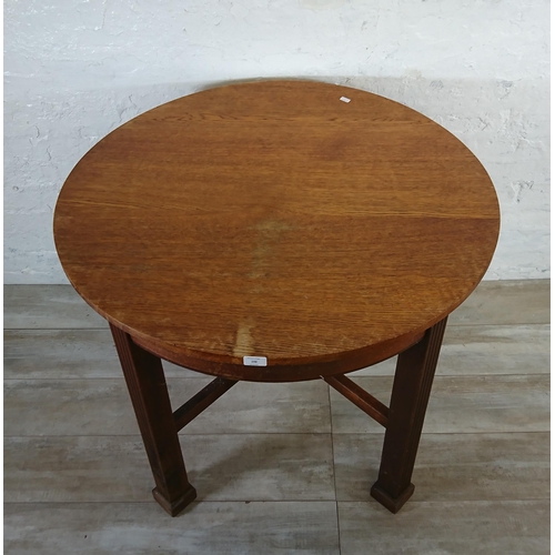 198 - A Waring & Gillow Ltd oak circular dining table - approx. 77cm high x 91cm diameter