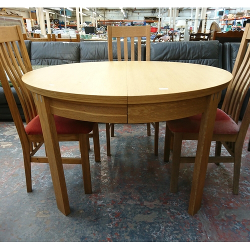 199 - A modern oak circular extending dining table and four chairs - approx. 75cm high x 120cm diameter