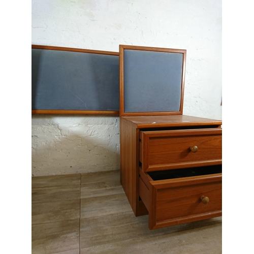 205 - A pair of G Plan teak and blue fabric two drawer bedside cabinets with matching headboard