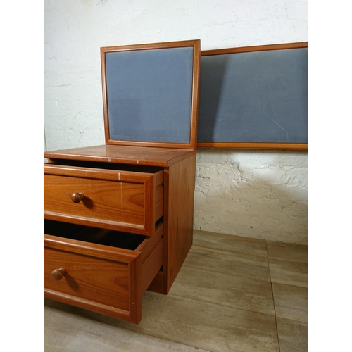 205 - A pair of G Plan teak and blue fabric two drawer bedside cabinets with matching headboard