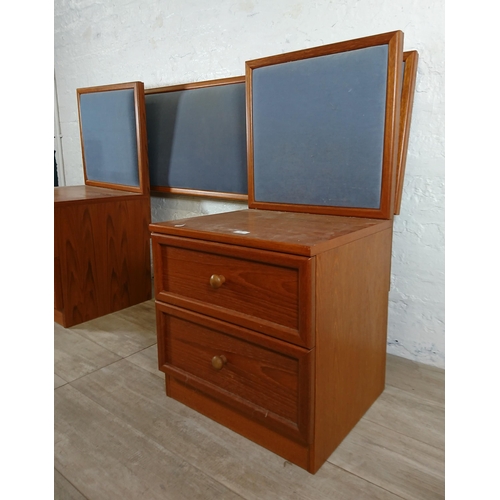 205 - A pair of G Plan teak and blue fabric two drawer bedside cabinets with matching headboard