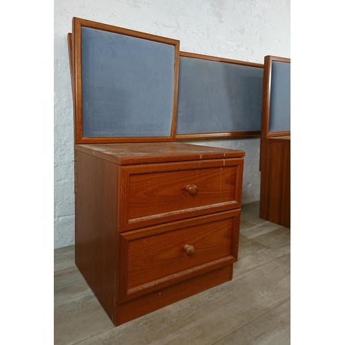 205 - A pair of G Plan teak and blue fabric two drawer bedside cabinets with matching headboard