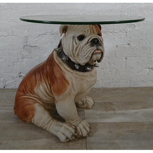 206 - A resin bulldog side table with glass top - approx. 56cm high x 55cm diameter