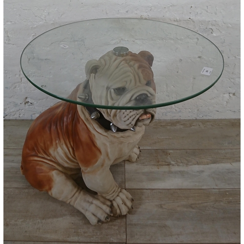 206 - A resin bulldog side table with glass top - approx. 56cm high x 55cm diameter