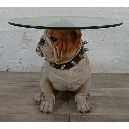 206 - A resin bulldog side table with glass top - approx. 56cm high x 55cm diameter