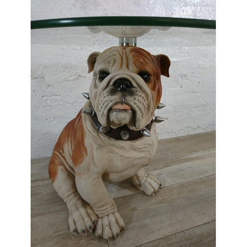 206 - A resin bulldog side table with glass top - approx. 56cm high x 55cm diameter