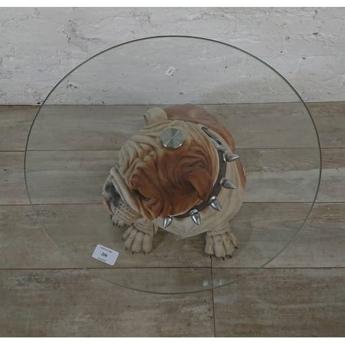 206 - A resin bulldog side table with glass top - approx. 56cm high x 55cm diameter