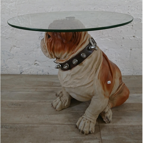 206 - A resin bulldog side table with glass top - approx. 56cm high x 55cm diameter