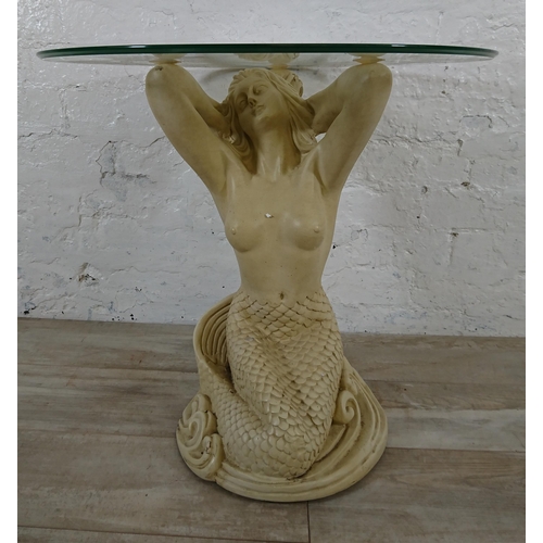 207 - A resin mermaid side table with glass top - approx. 57cm high x 61cm diameter