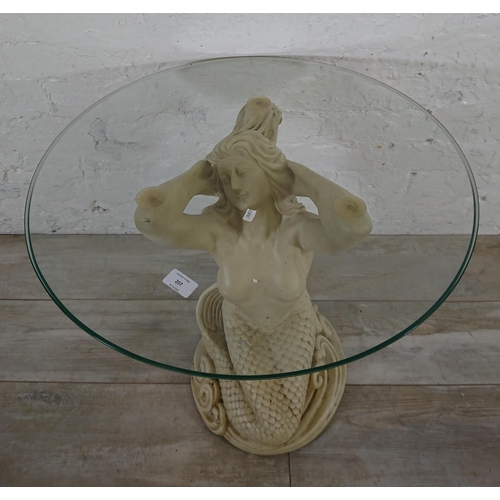 207 - A resin mermaid side table with glass top - approx. 57cm high x 61cm diameter