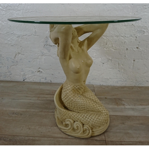 207 - A resin mermaid side table with glass top - approx. 57cm high x 61cm diameter