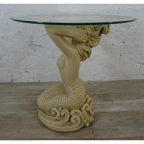 207 - A resin mermaid side table with glass top - approx. 57cm high x 61cm diameter