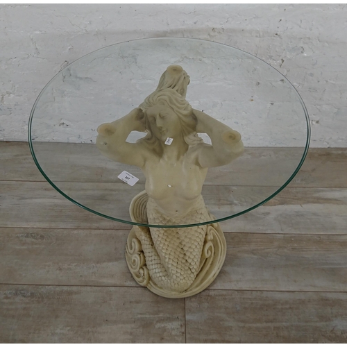 207 - A resin mermaid side table with glass top - approx. 57cm high x 61cm diameter