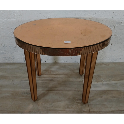 208 - A mid 20th century Art Deco style copper tinted mirrored glass side table - approx. 56cm high x 66cm... 