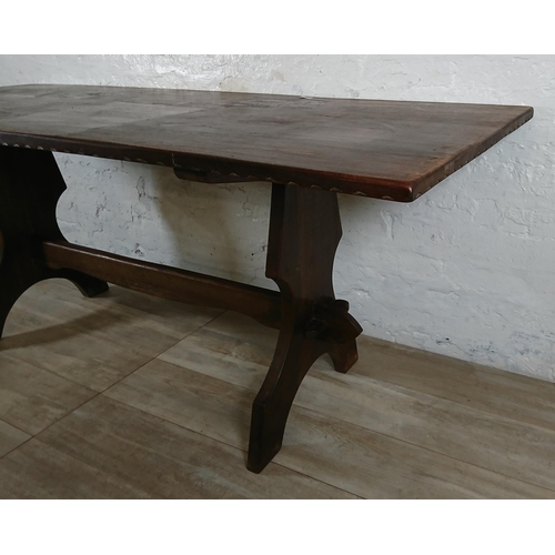 215A - A Nigel Griffiths carved oak dining table and six leather chairs - table approx. 72cm high x 74cm wi... 