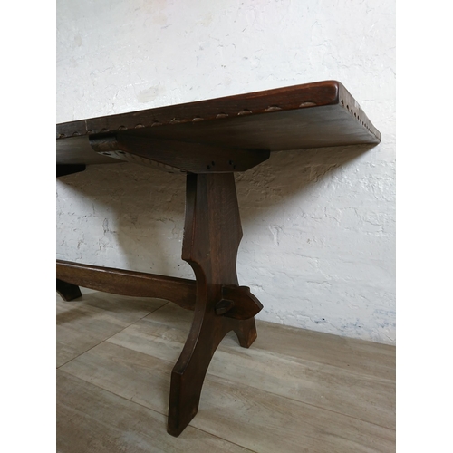 215A - A Nigel Griffiths carved oak dining table and six leather chairs - table approx. 72cm high x 74cm wi... 