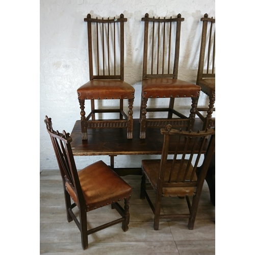 215A - A Nigel Griffiths carved oak dining table and six leather chairs - table approx. 72cm high x 74cm wi... 