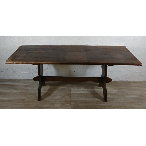 215A - A Nigel Griffiths carved oak dining table and six leather chairs - table approx. 72cm high x 74cm wi... 