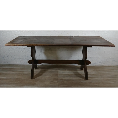 215A - A Nigel Griffiths carved oak dining table and six leather chairs - table approx. 72cm high x 74cm wi... 