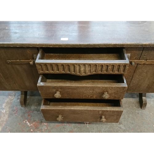 215B - A Nigel Griffiths carved oak sideboard - approx. 76cm high x 168cm wide x 46cm deep