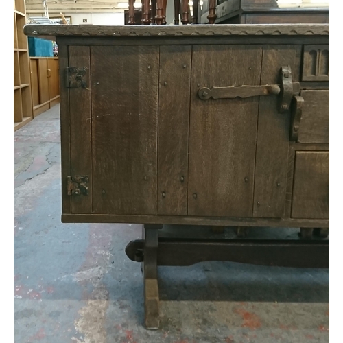 215B - A Nigel Griffiths carved oak sideboard - approx. 76cm high x 168cm wide x 46cm deep