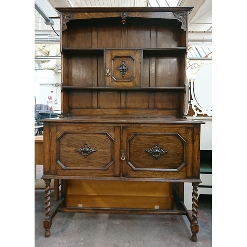 217 - An early 20th century carved oak dresser on barley twist supports - approx. 185cm high x 122cm wide ... 