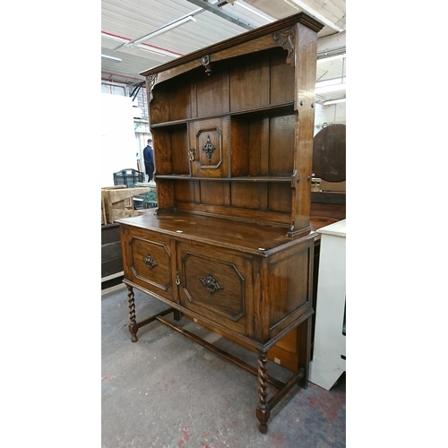 217 - An early 20th century carved oak dresser on barley twist supports - approx. 185cm high x 122cm wide ... 