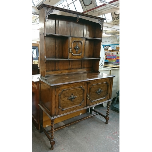 217 - An early 20th century carved oak dresser on barley twist supports - approx. 185cm high x 122cm wide ... 