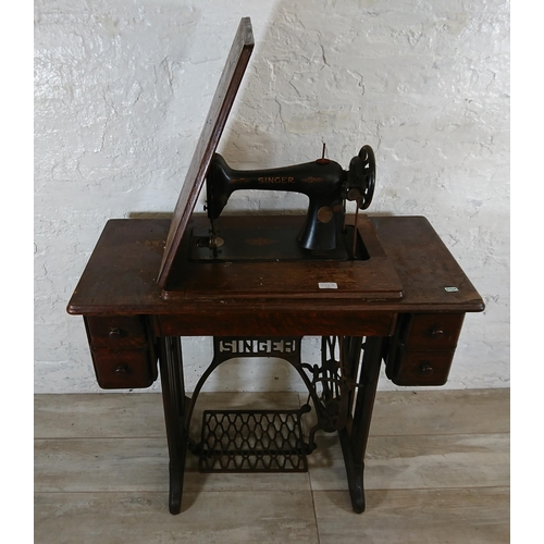 220A - A 1930 Singer 66K treadle sewing machine with oak and cast iron table - serial no. Y7983218