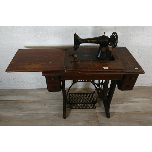 220A - A 1930 Singer 66K treadle sewing machine with oak and cast iron table - serial no. Y7983218