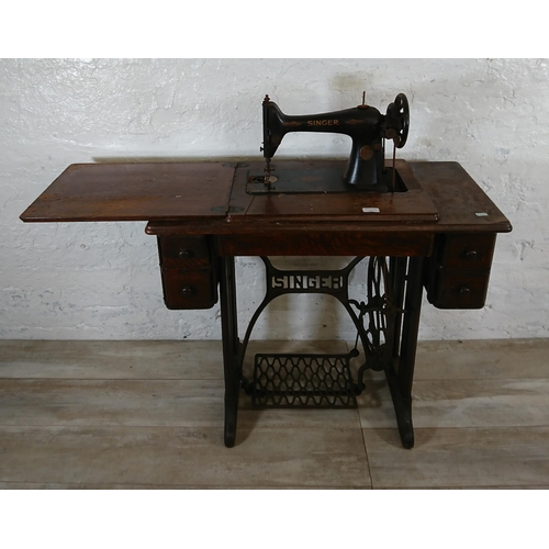 220A - A 1930 Singer 66K treadle sewing machine with oak and cast iron table - serial no. Y7983218