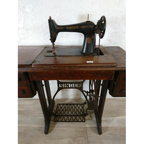 220A - A 1930 Singer 66K treadle sewing machine with oak and cast iron table - serial no. Y7983218