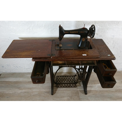 220A - A 1930 Singer 66K treadle sewing machine with oak and cast iron table - serial no. Y7983218