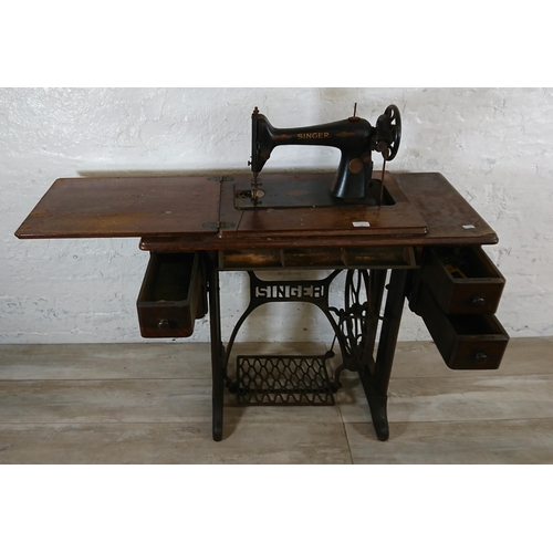 220A - A 1930 Singer 66K treadle sewing machine with oak and cast iron table - serial no. Y7983218