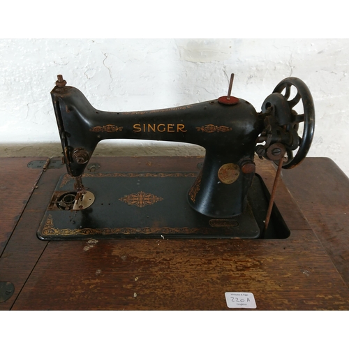 220A - A 1930 Singer 66K treadle sewing machine with oak and cast iron table - serial no. Y7983218