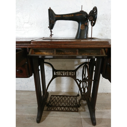 220A - A 1930 Singer 66K treadle sewing machine with oak and cast iron table - serial no. Y7983218