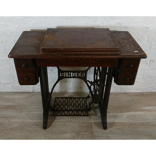 220A - A 1930 Singer 66K treadle sewing machine with oak and cast iron table - serial no. Y7983218