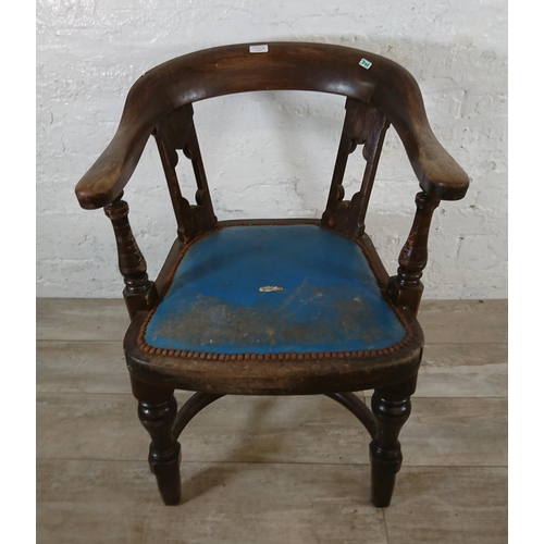 220B - An early 20th century elm and beech captains desk chair with later added blue vinyl upholstery